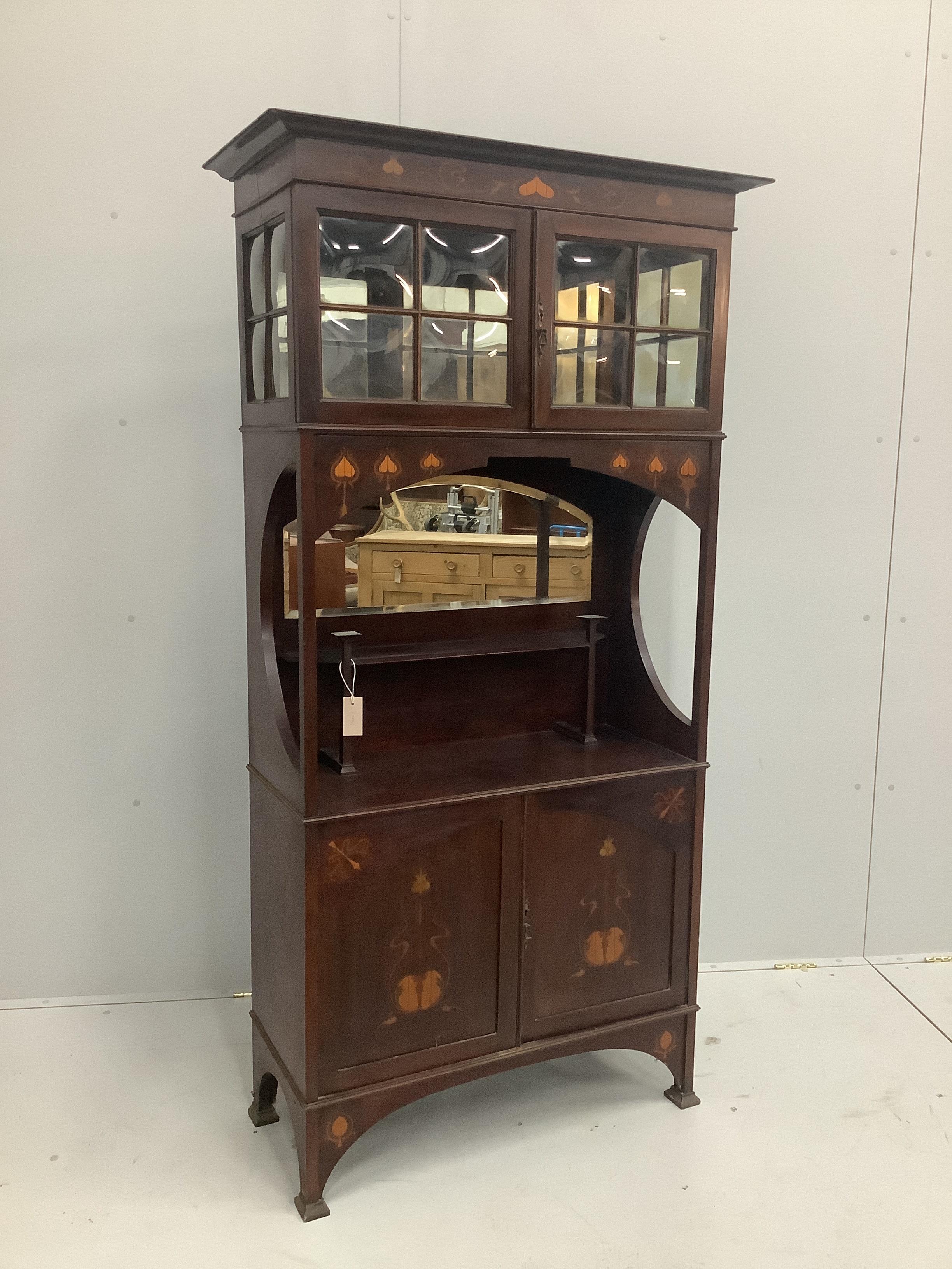 An Edwardian Arts and Crafts mahogany display cabinet with stencilled decoration, width 91cm, height 177cm